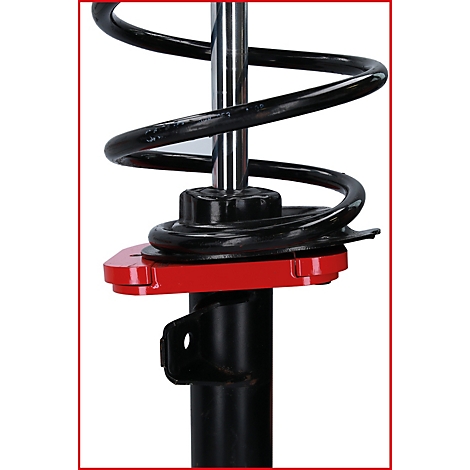 Nahaufnahme eines Stoßdämpfers. Eine schwarze Schraubenfeder windet sich um eine Metallstange. Darunter ein rotes Element und schwarze Halterung.